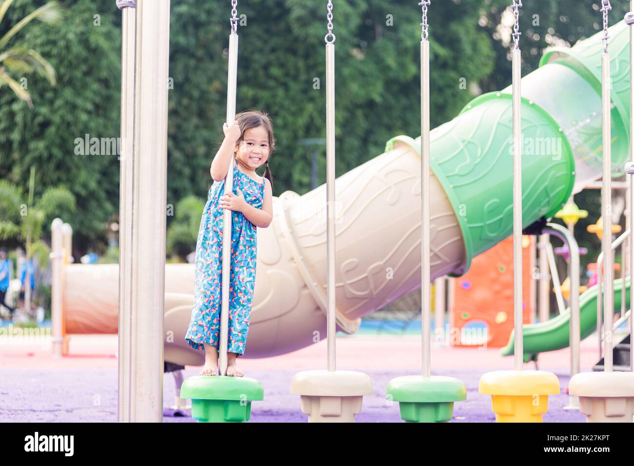 child playing on outdoor playground, happy preschool little kid having funny while playing on the playground Stock Photo