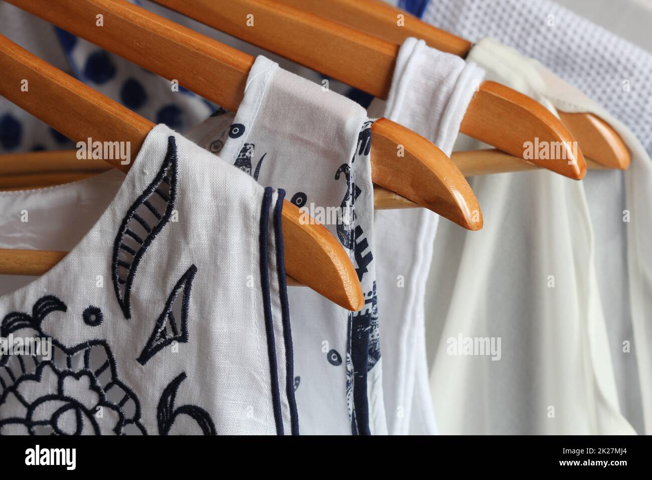 Summer collection of women's clothes hanging on a rack Stock Photo - Alamy