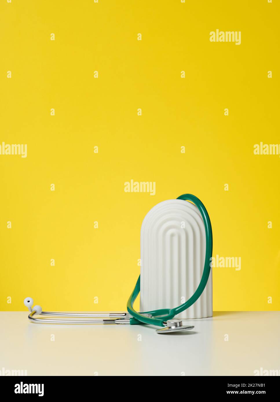 green medical stethoscope on yellow background Stock Photo - Alamy