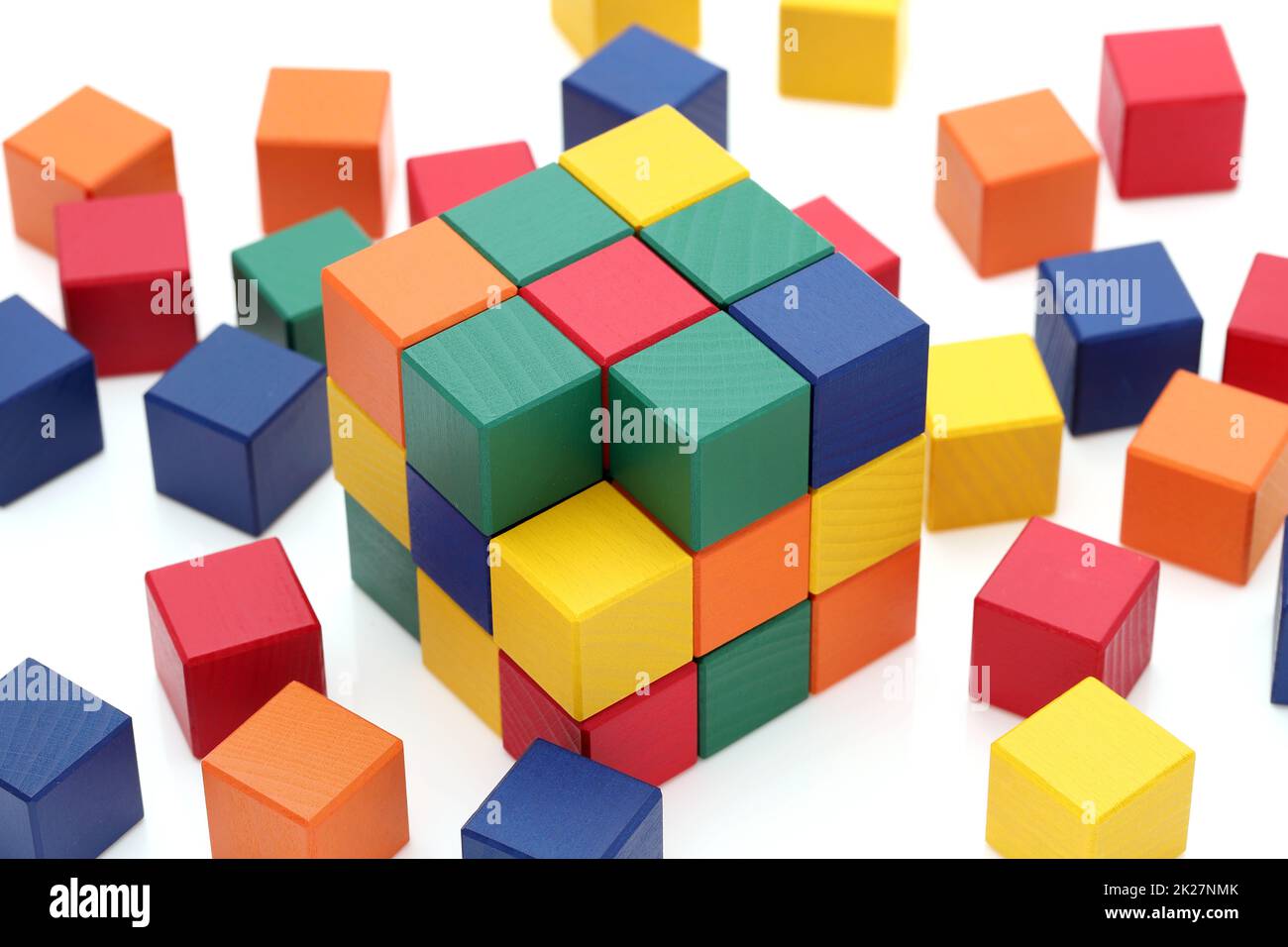 small wooden colorful square blocks puzzle on a white background Stock Photo