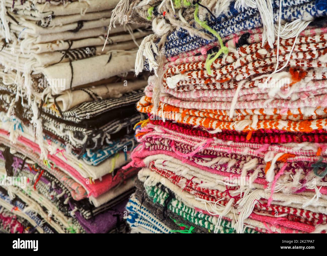 Colourful textile rugs or blankets displayed on street market in Marrakesh, Morocco - closeup detail Stock Photo