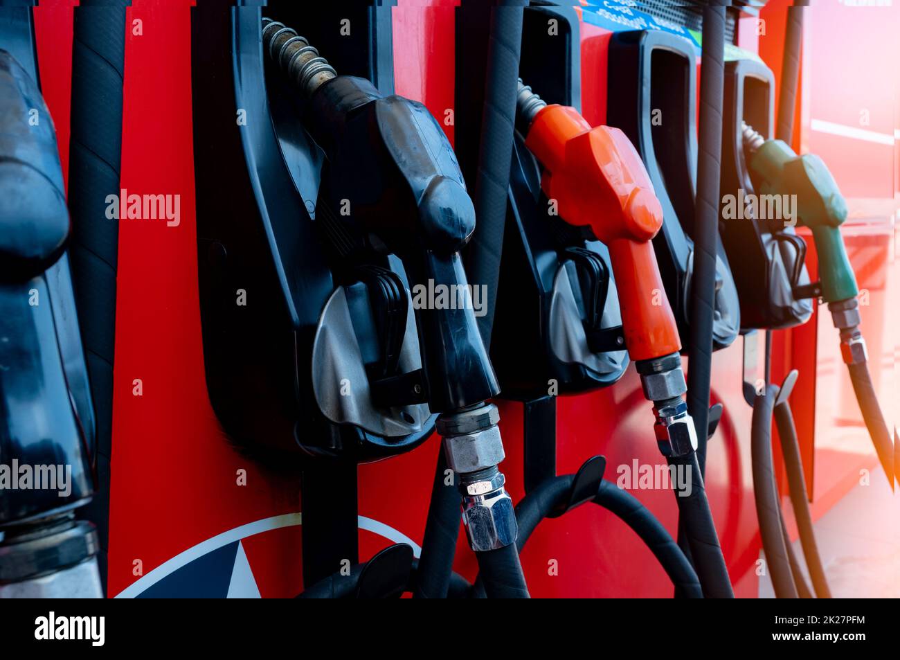 Gas pump nozzle in petrol station. Fuel nozzle in oil dispenser. Fuel dispenser machine. Refueling fill up with petrol gasoline and diesel. Petrol industry and service. Petroleum oil consumption. Stock Photo