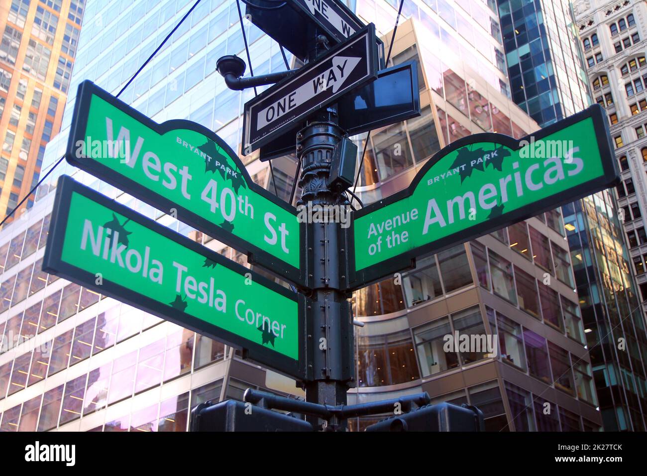 Green West 40th Street and Avenue of the Americas 6th ( Nikola Tesla corner ) Bryant Park traditional sign in Midtown Manhattan in New York City Stock Photo