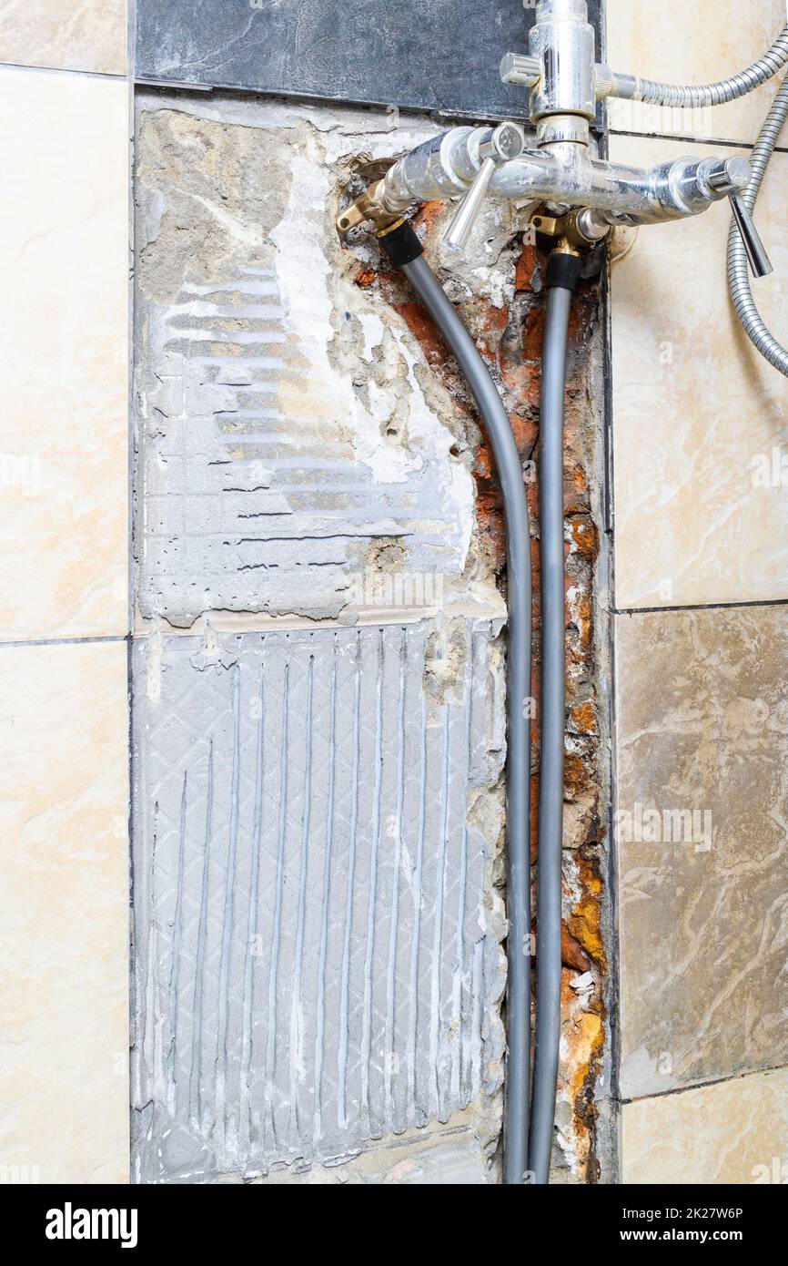 new water pipes connected to old shower faucet Stock Photo