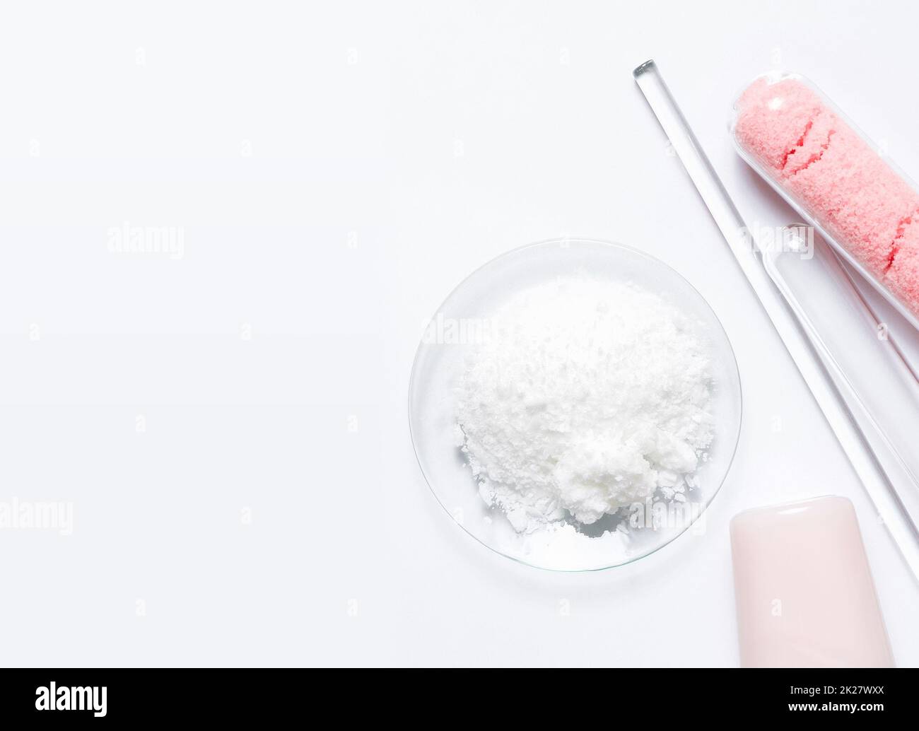 Beauty care cream, himalayan pink salt and Polyacrylic acid powder placed next to Stirring Rod and Test tube. Chemicals for beauty care on white laboratory table. (Top View) Stock Photo