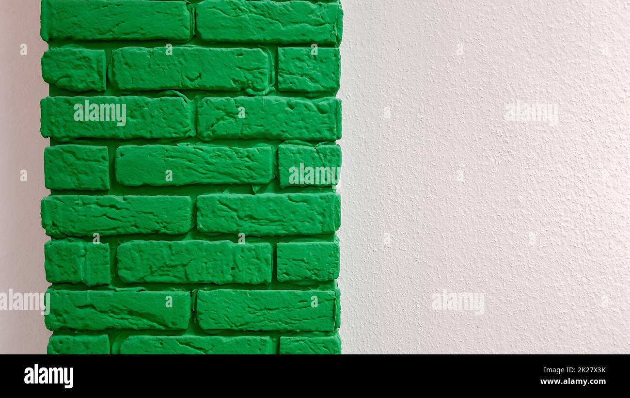 Modern new flat pink wall with a decorative brick column painted green ...
