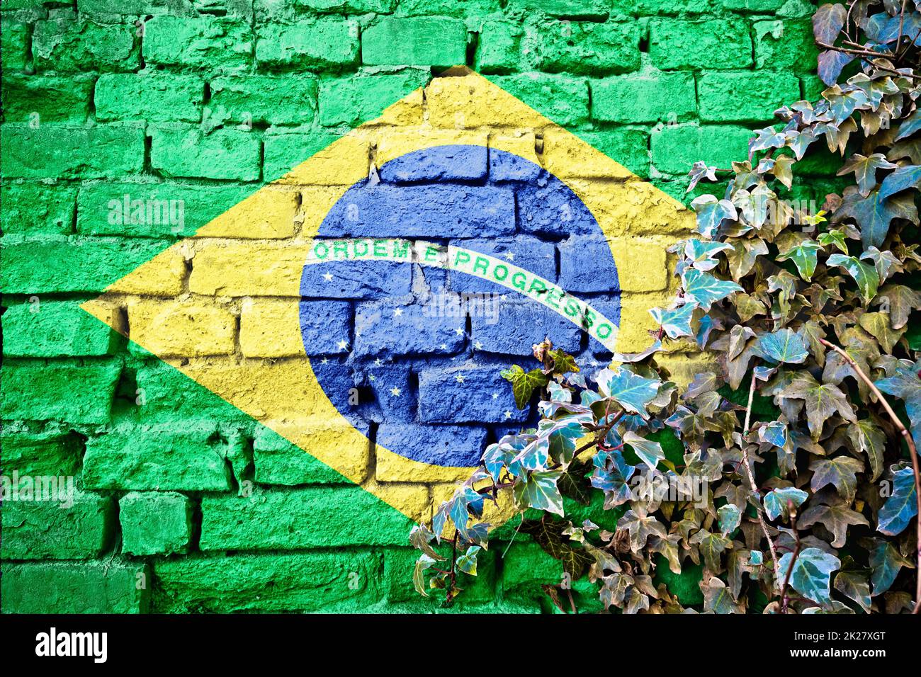 Brasil grunge flag on brick wall with ivy plant Stock Photo