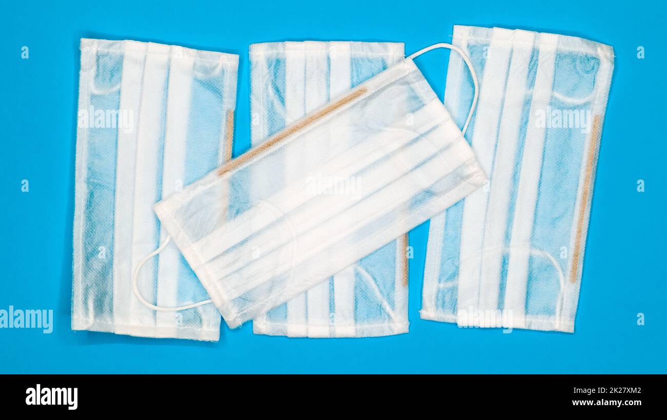 Four disposable surgical face masks with rubber pads to cover the mouth