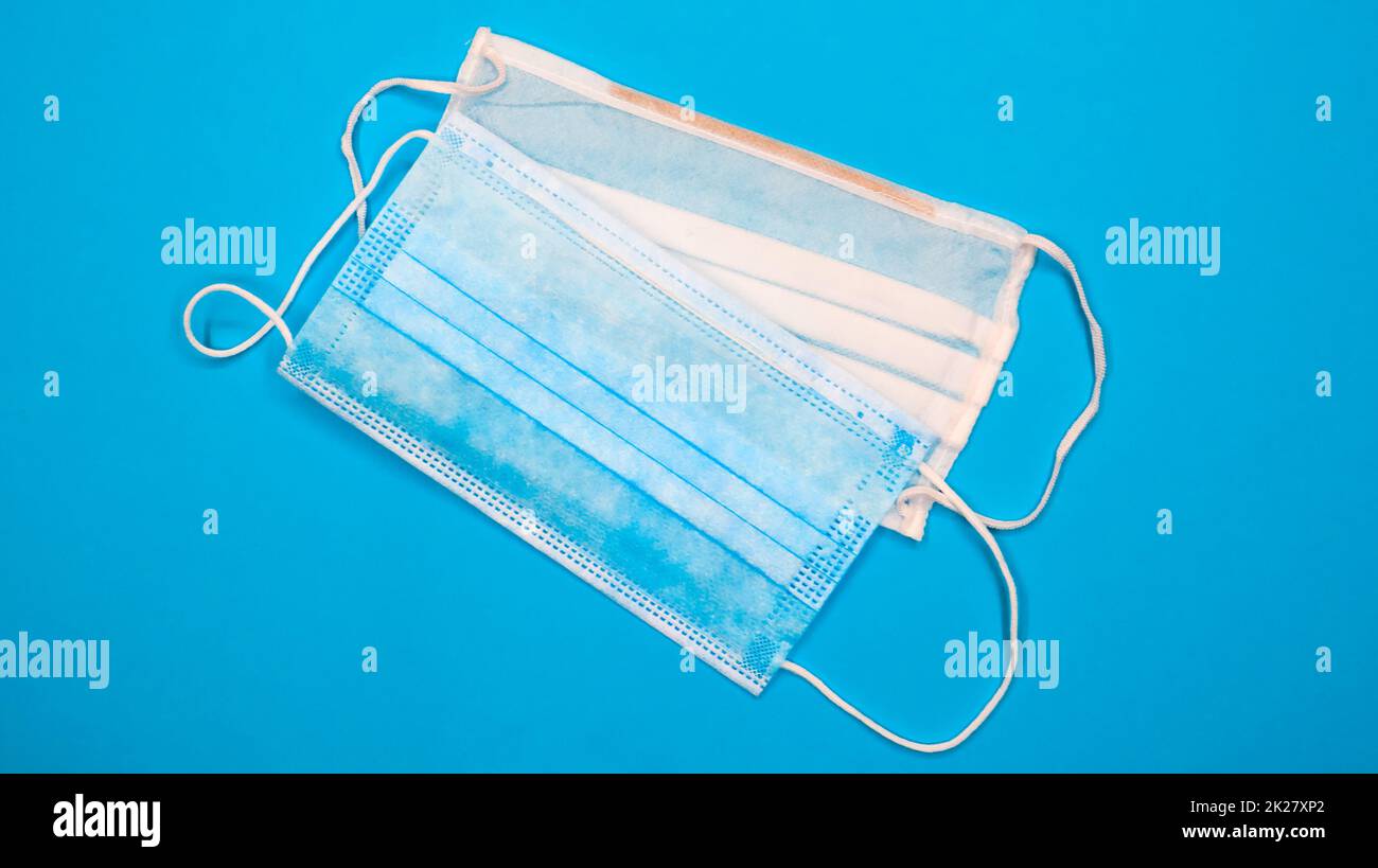 Two threelayer disposable surgical face masks with rubber pads to