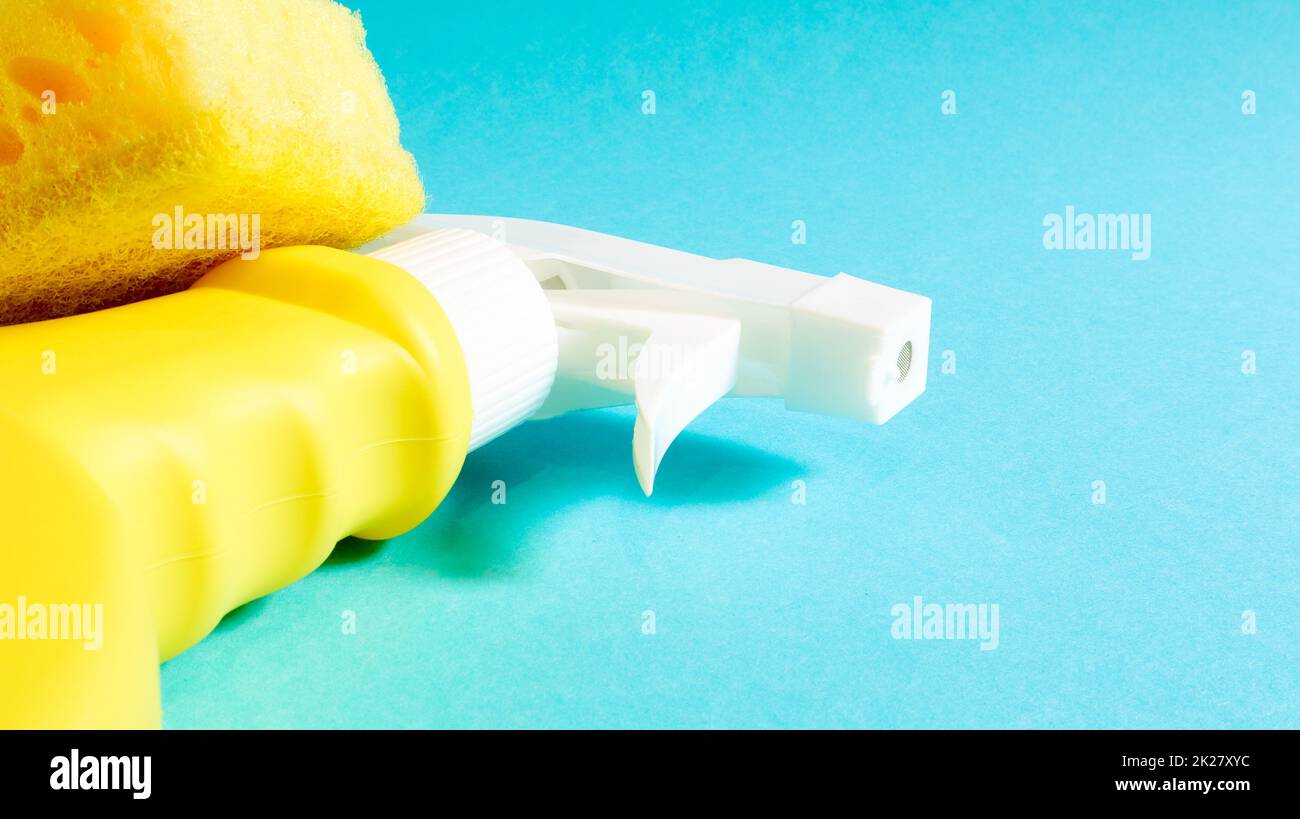 Set of cleaning products on a blue background. Yellow rag and sponge, cleaning spray, detergent. House cleaning concept. Stock Photo