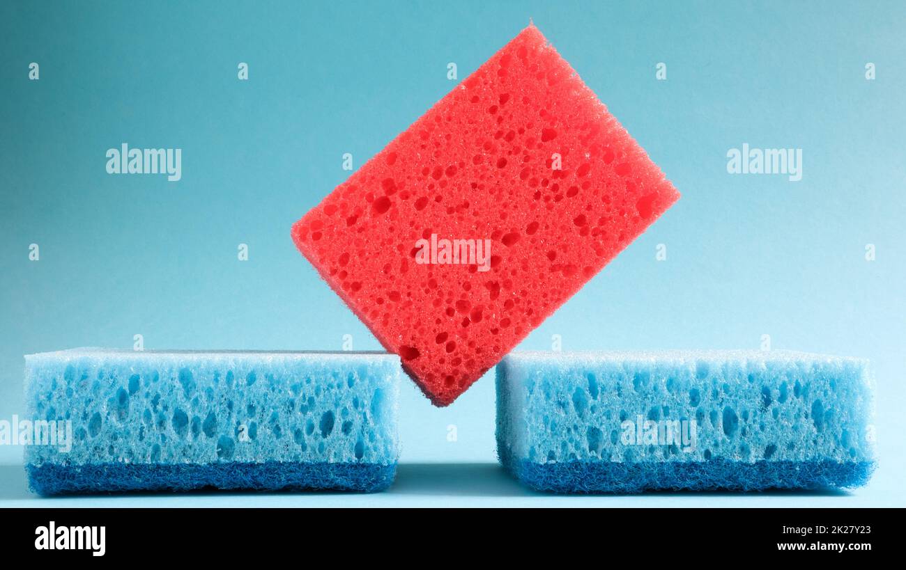 Many blue, red, yellow, green sponges are used to wash and wipe the dirt used by housewives in everyday life. They are made of porous material such as foam. good detergent retention Stock Photo