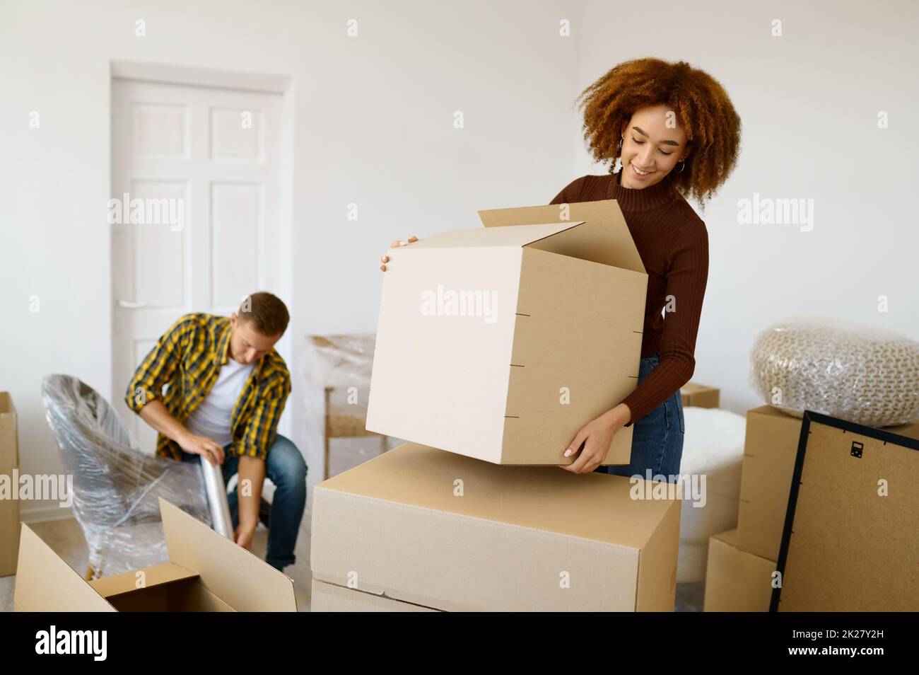 Happy couple packing beginnings before home moving Stock Photo