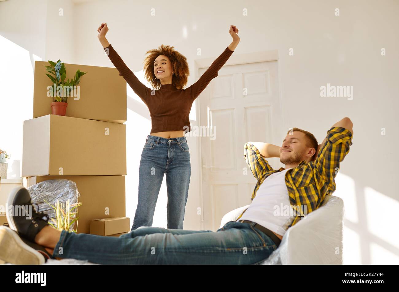 Happy couple rejoicing moving to new house Stock Photo