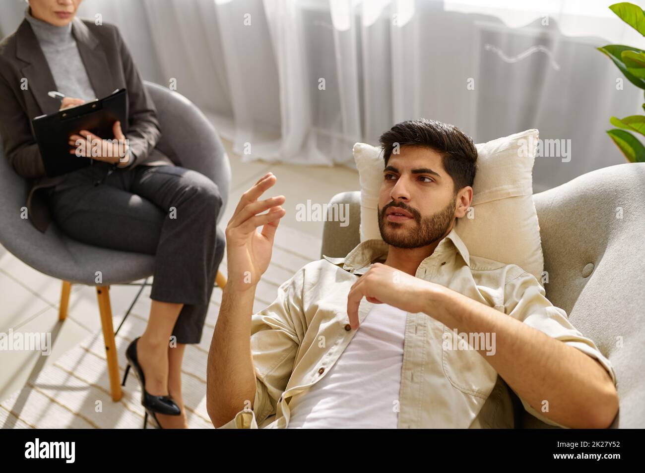 Female psychologist working with man on couch Stock Photo Alamy