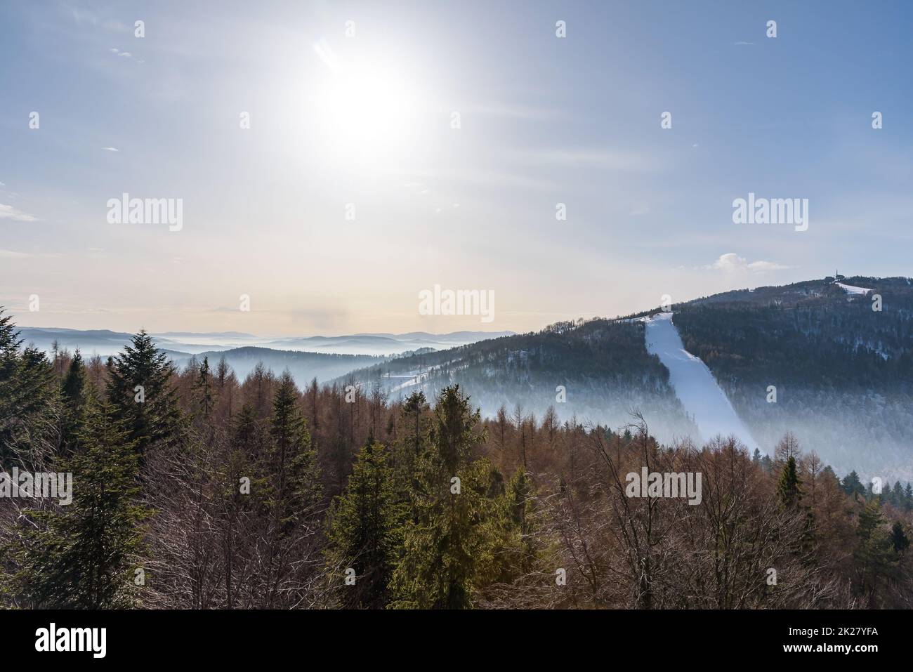 Foggy view of Beskid Sadecki mountain range on a sunny day Stock Photo
