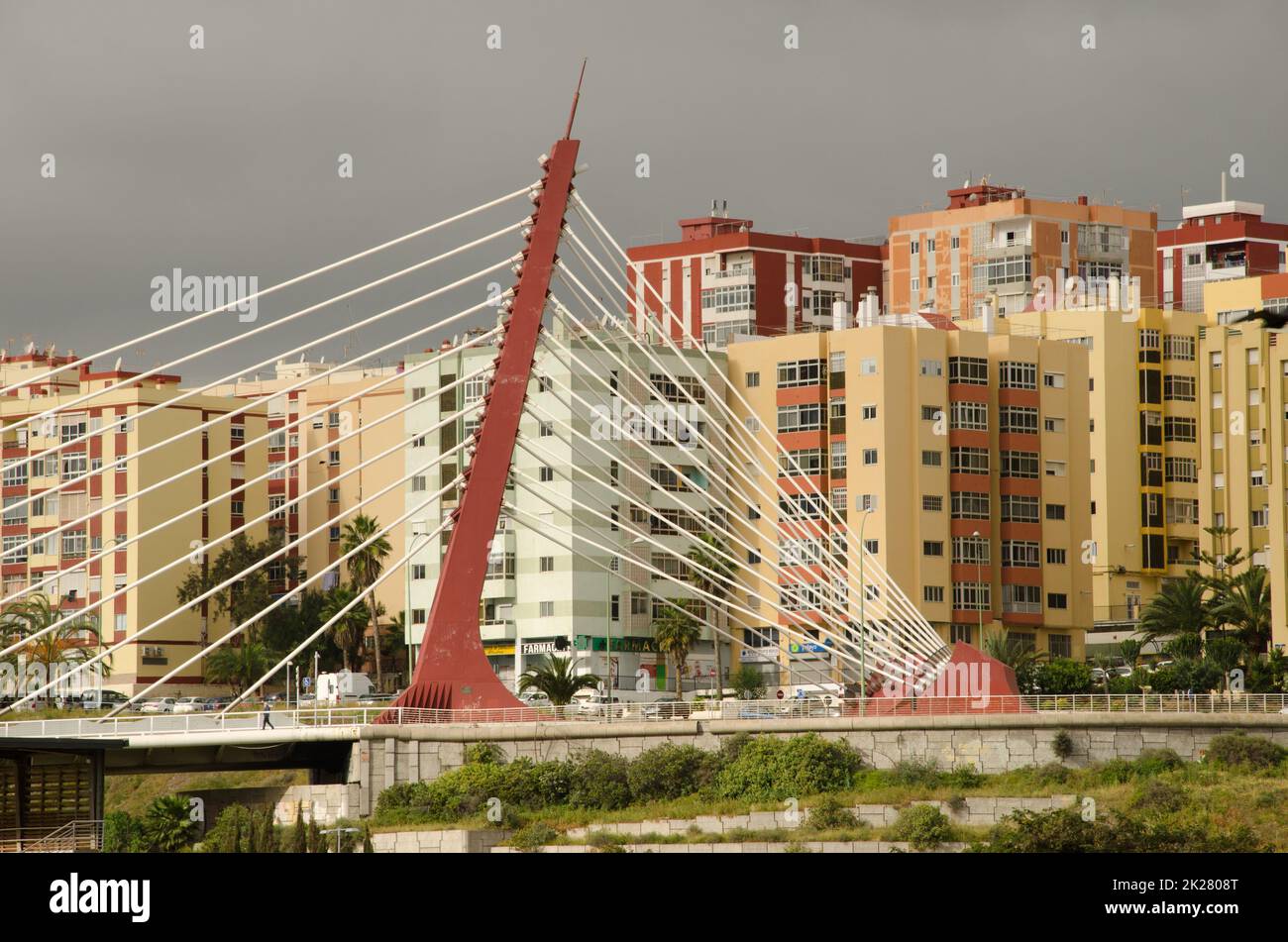 Cable-stayed bridge over a ravine and buildings. Stock Photo