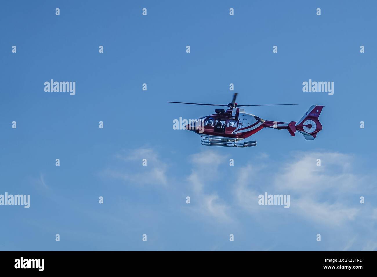 Europe, France, Dunkerque - July 9, 2022: Port scenery. Bordeaux-white Helicopter flies over under blue sky delivering pilot for ships entering harbor Stock Photo