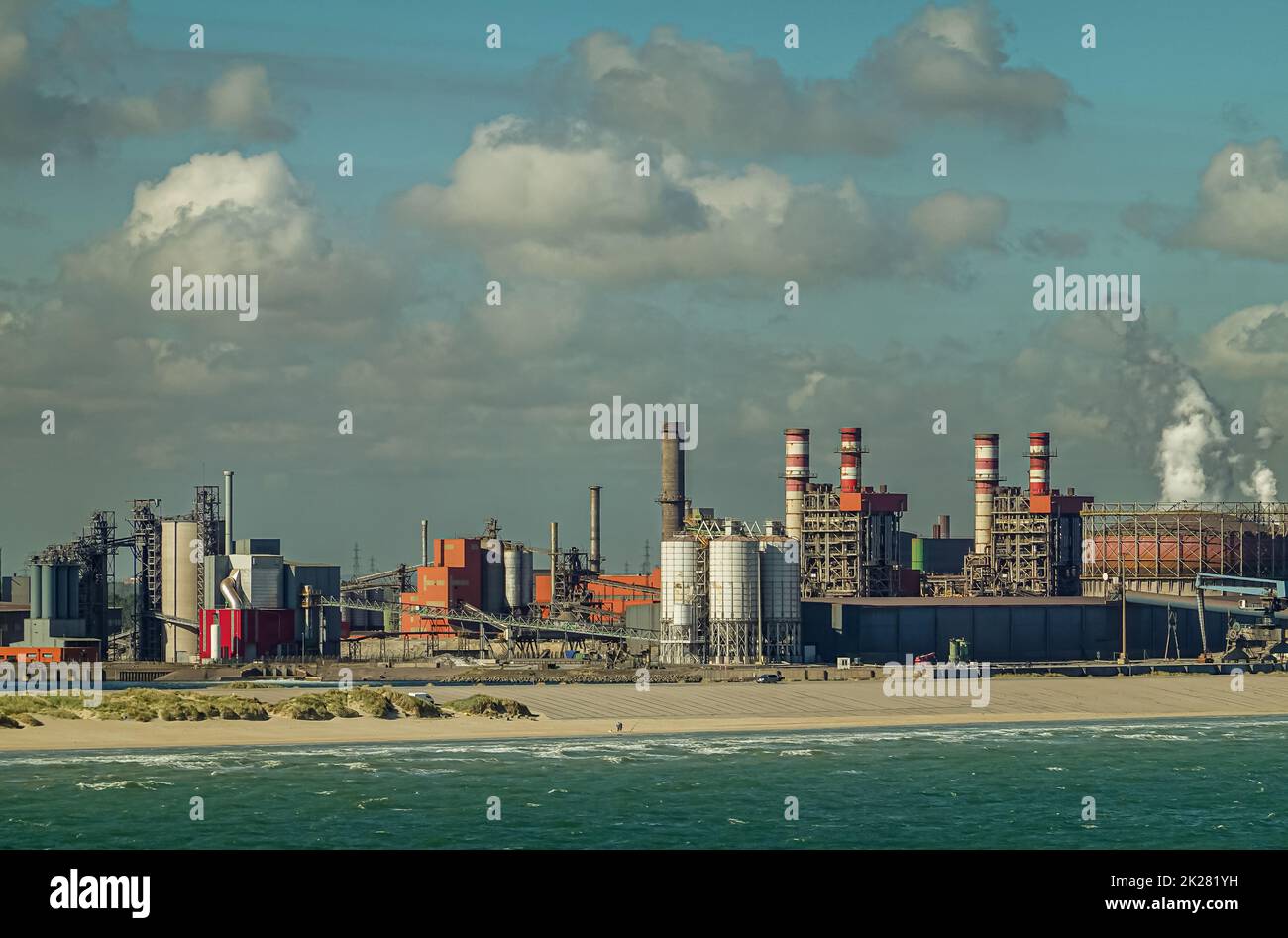 Europe, France, Dunkerque - July 9, 2022: Port scenery. Gas and Coal terminal at Energy dock with power generation plant under blue cloudscape. Azure Stock Photo