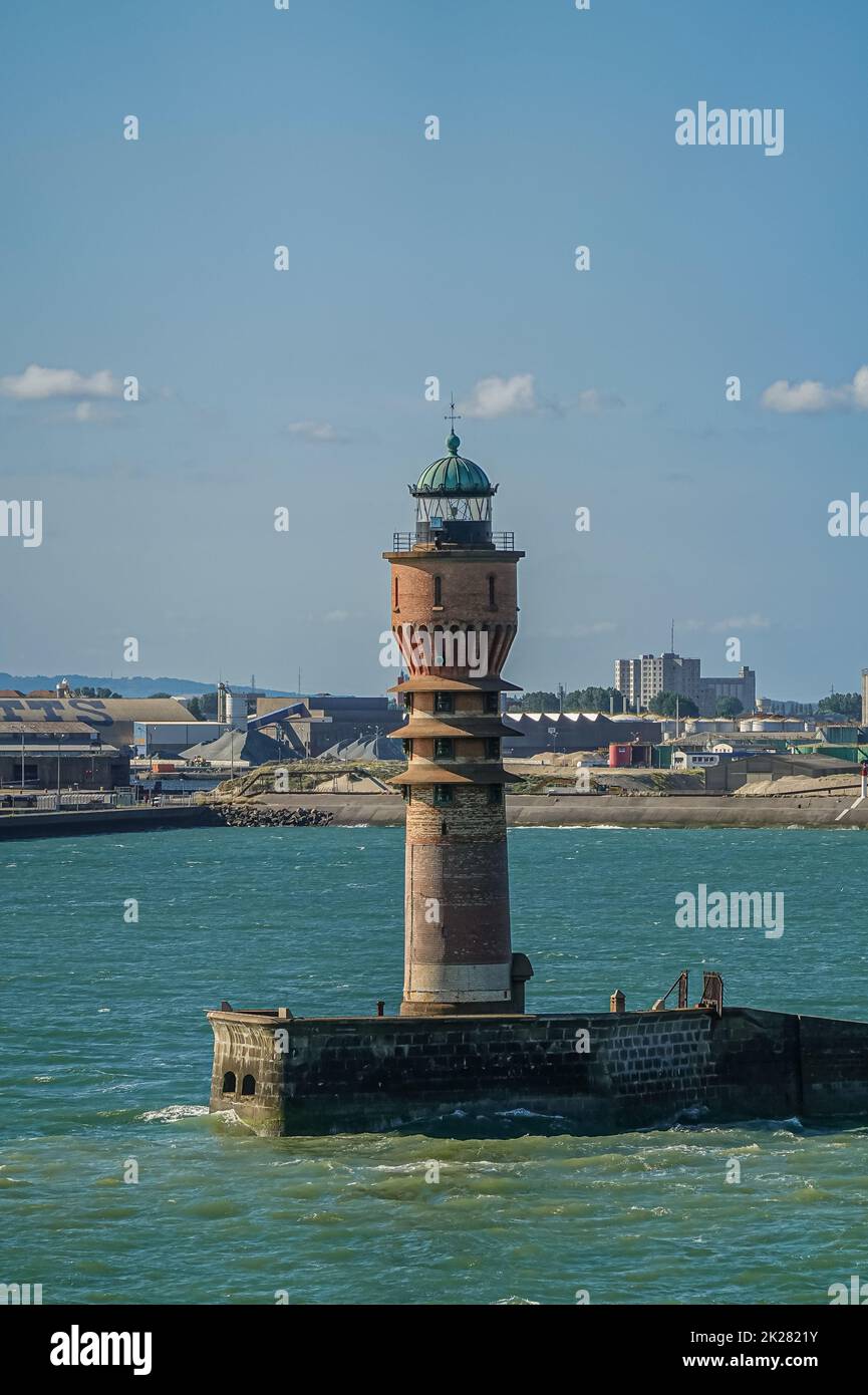 Europe, France, Dunkerque - July 9, 2022: Port scenery. Closeup of historic Feu de Saint Pol, light, tower on its pier marks entrance to harbor under Stock Photo
