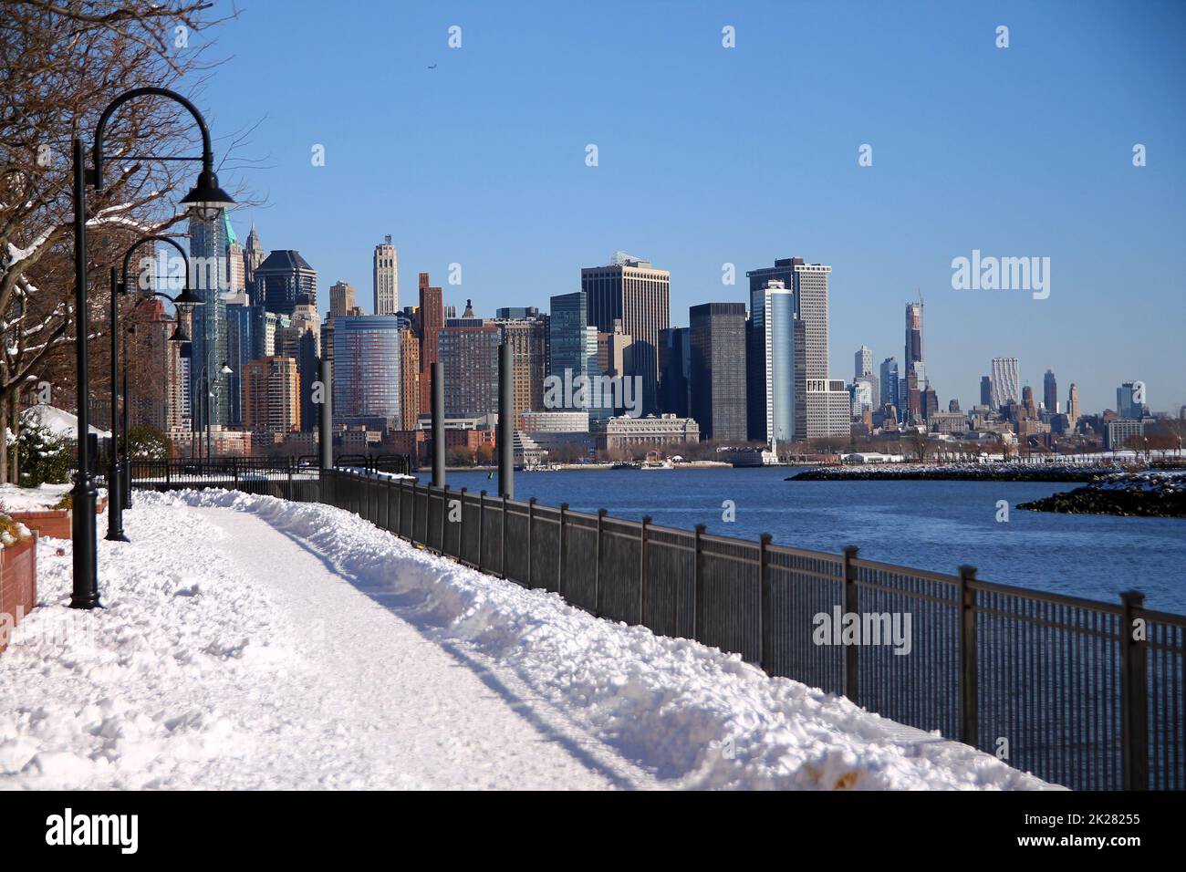 The snow path of the Hudson river walkaway with downtown Manhattan on the back Stock Photo