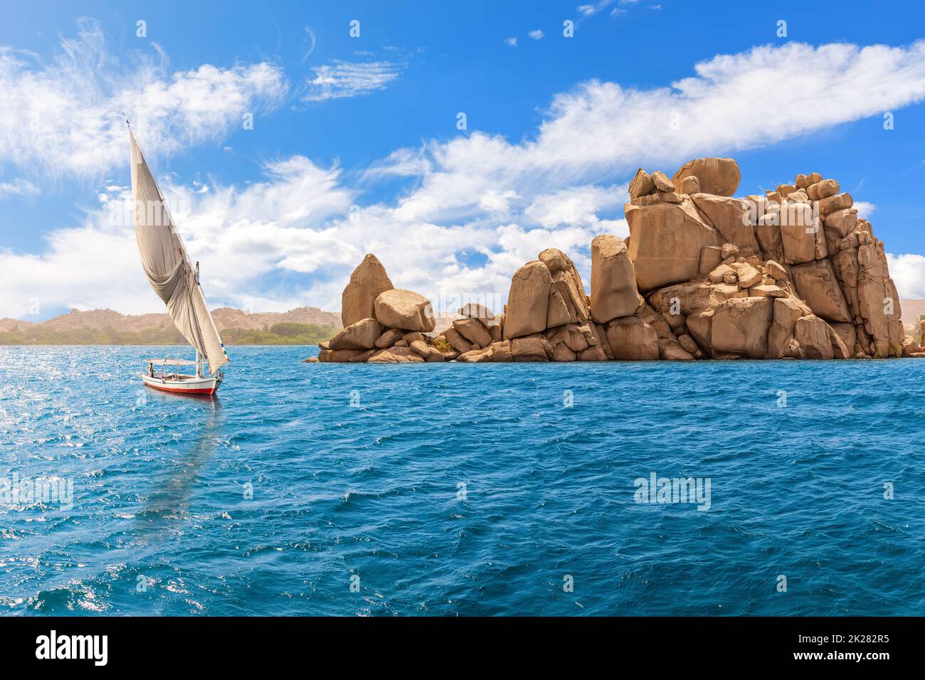 The Nile river, felucca and rocks by the Agilika island, Aswan, Egypt Stock Photo