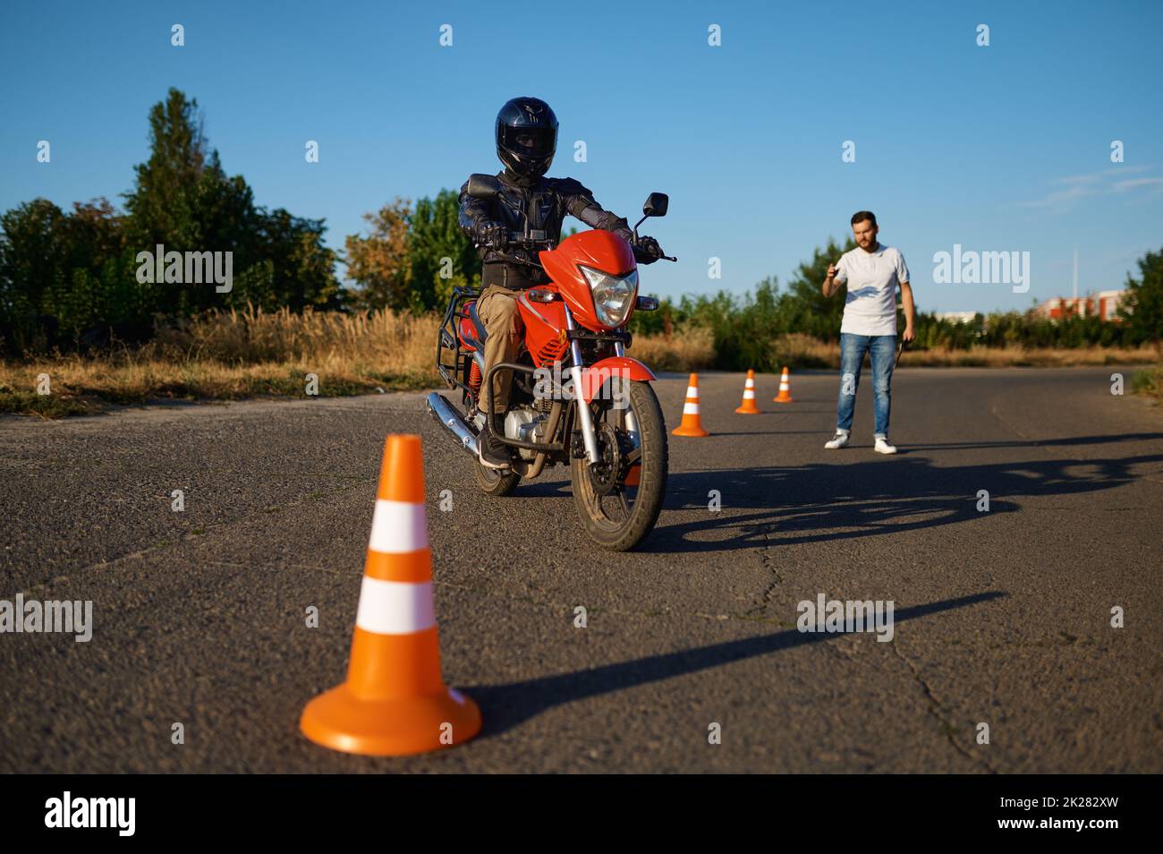 Student and instructor, exam in motorcycle school Stock Photo
