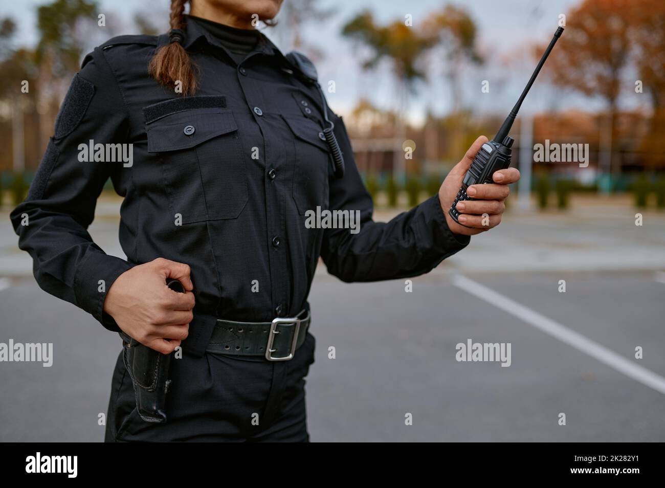 Patrol service police woman talking into walkie-talkie Stock Photo
