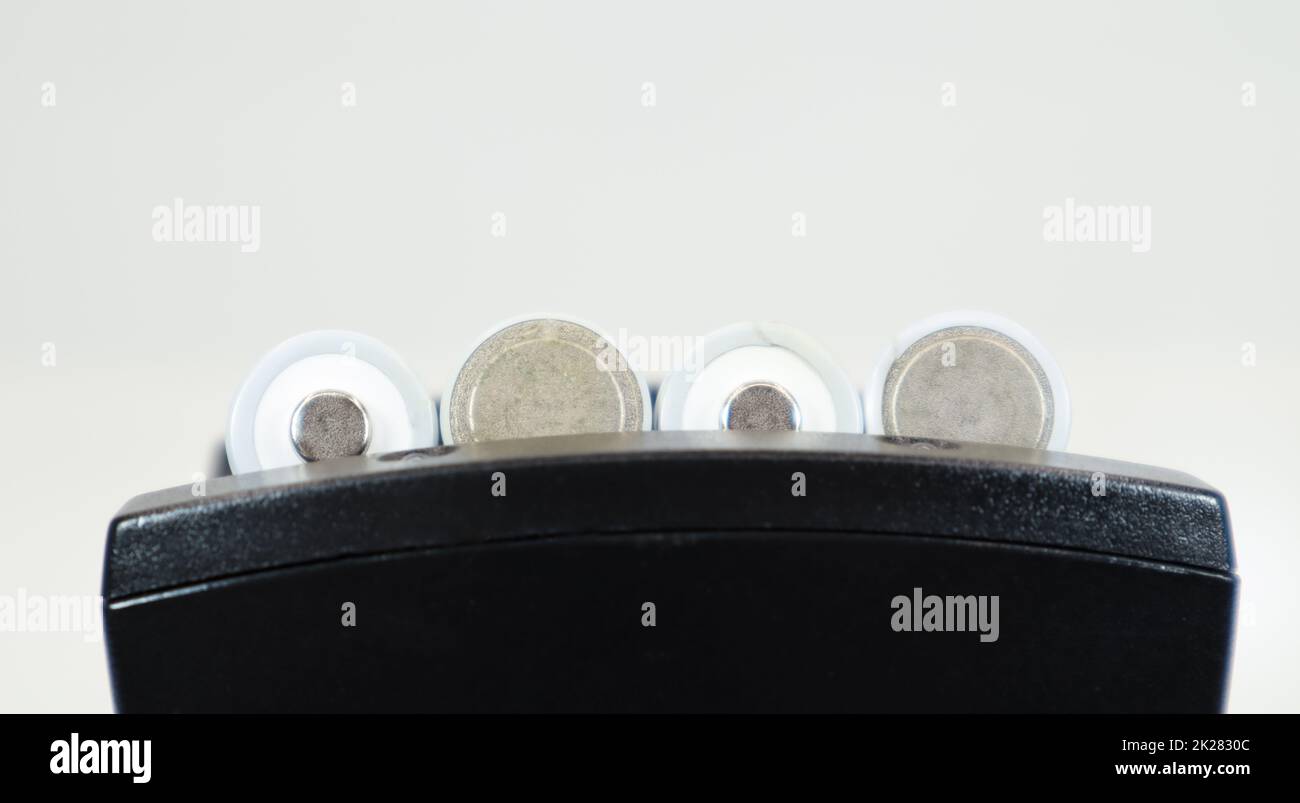 Fast charging of AA batteries. Rechargeable batteries in a black