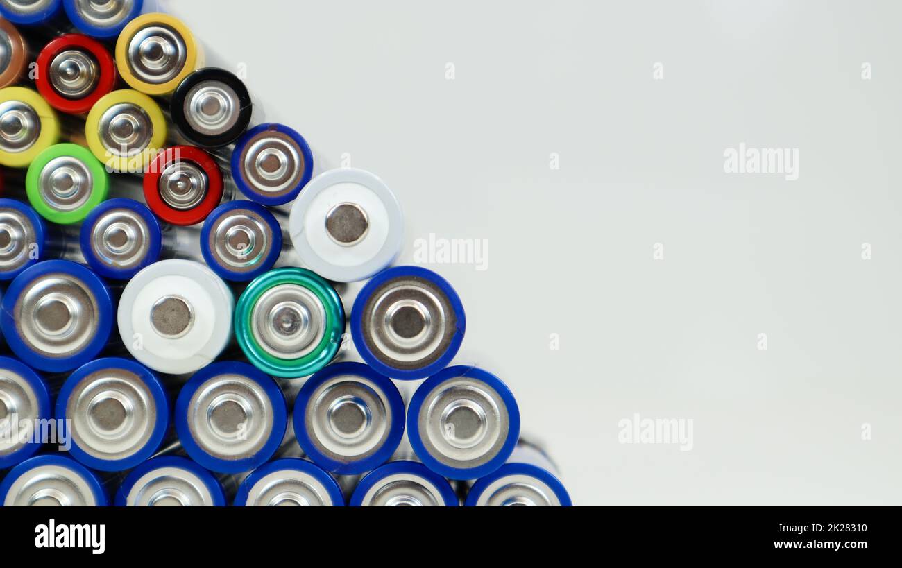 Lots of AA and AAA alkaline batteries on a white background. Ecological recycling concept. The