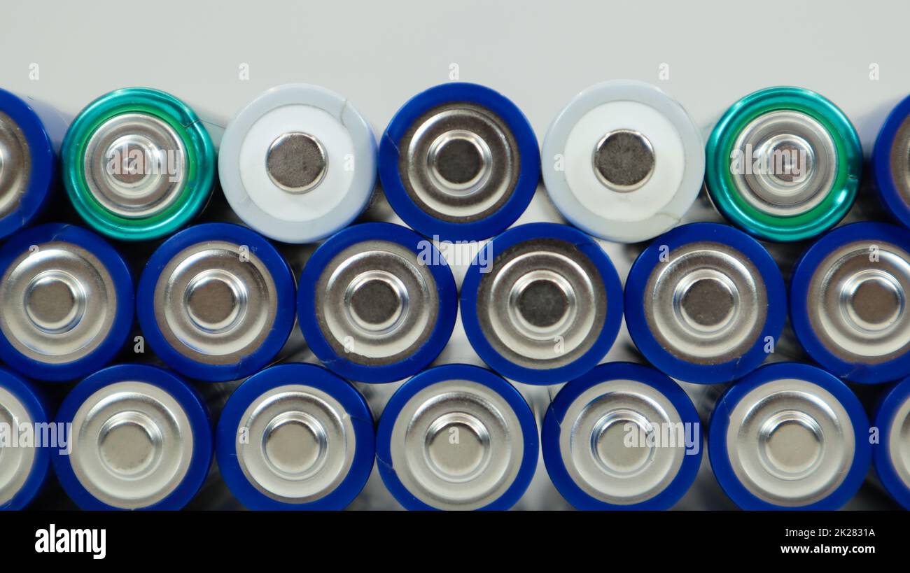Lots of AA and AAA alkaline batteries on a white background. Ecological