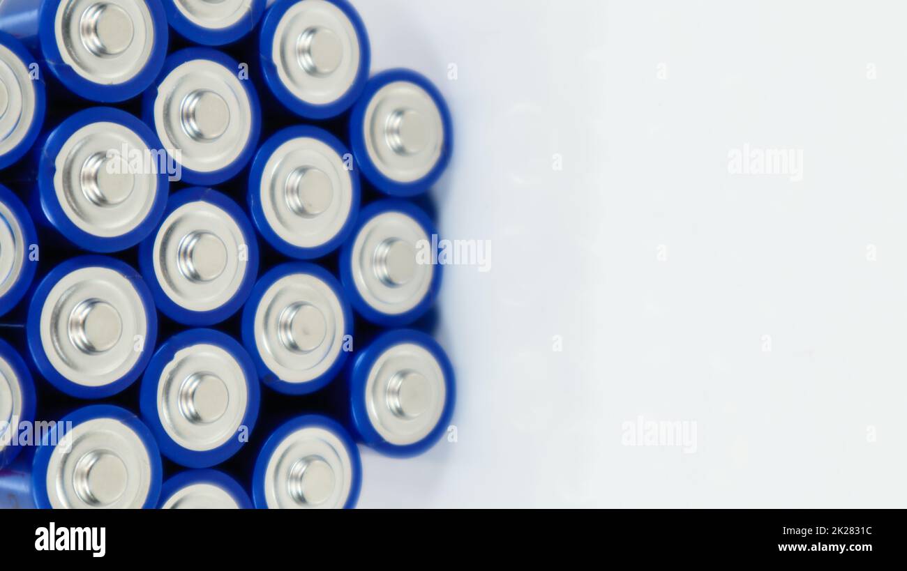 Lots of AA and AAA alkaline batteries on a white background. Ecological recycling concept. The