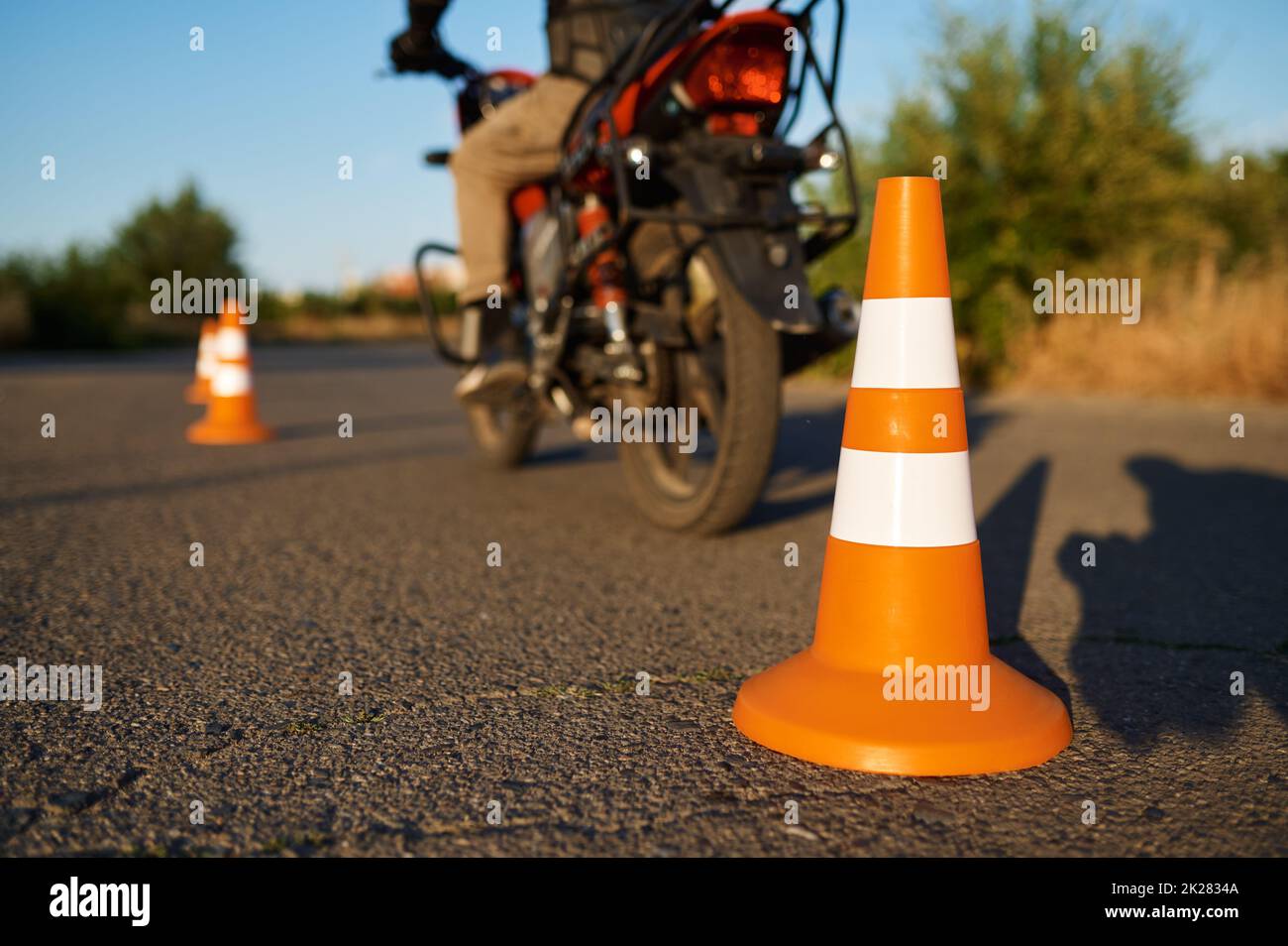 Student on motorbike, snake riding between cones Stock Photo