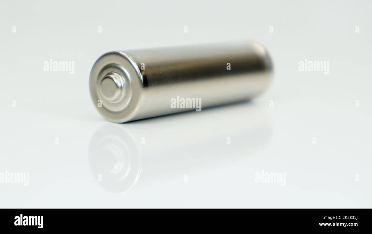 AA alkaline rechargeable battery on white glossy background with