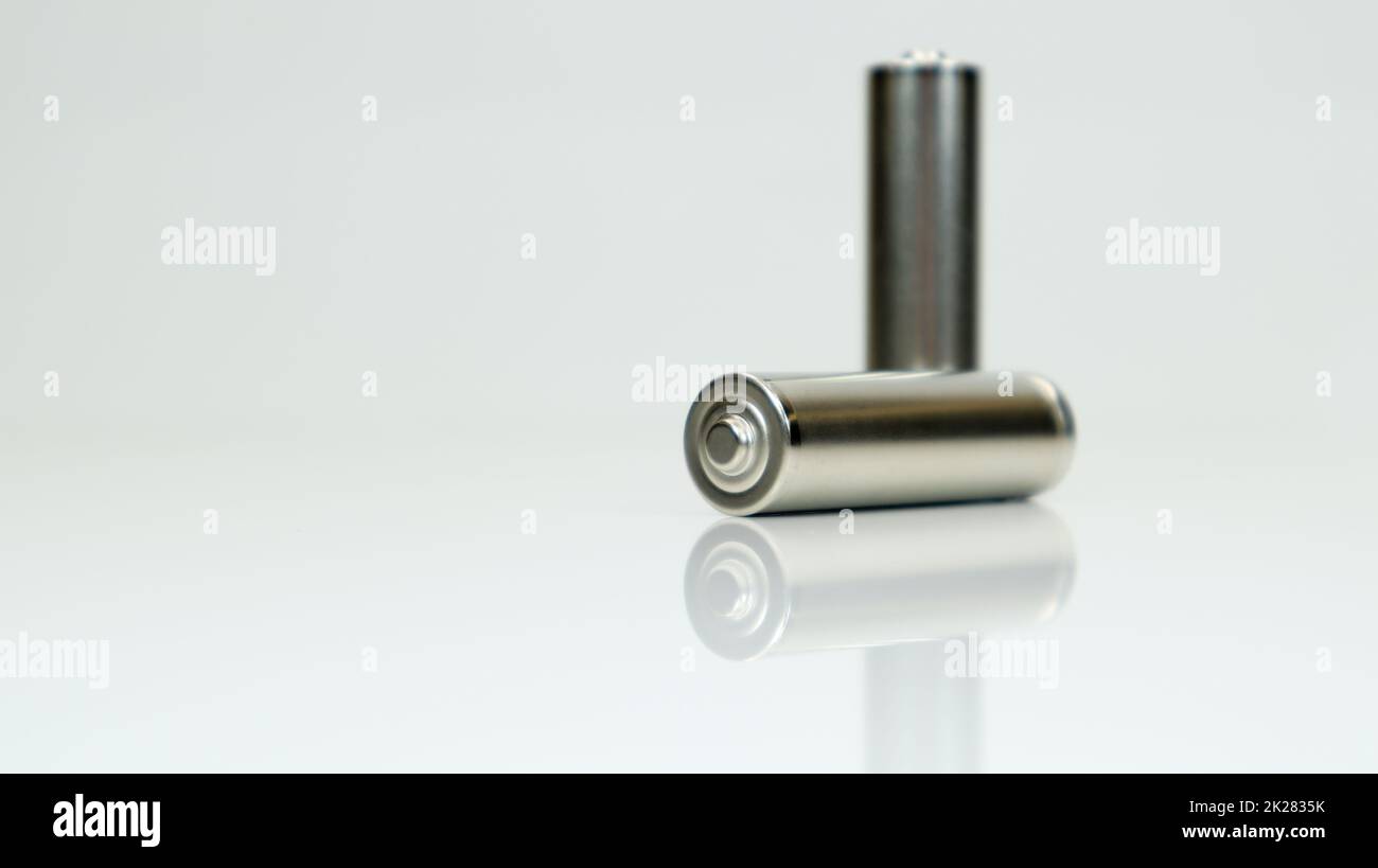 AA alkaline rechargeable batteries on white glossy background with