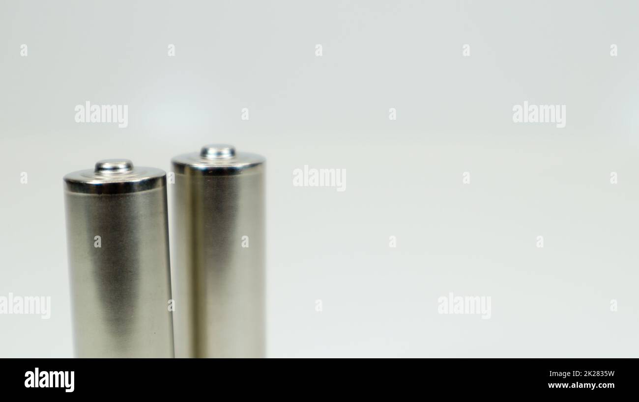 AA alkaline rechargeable batteries on white glossy background with