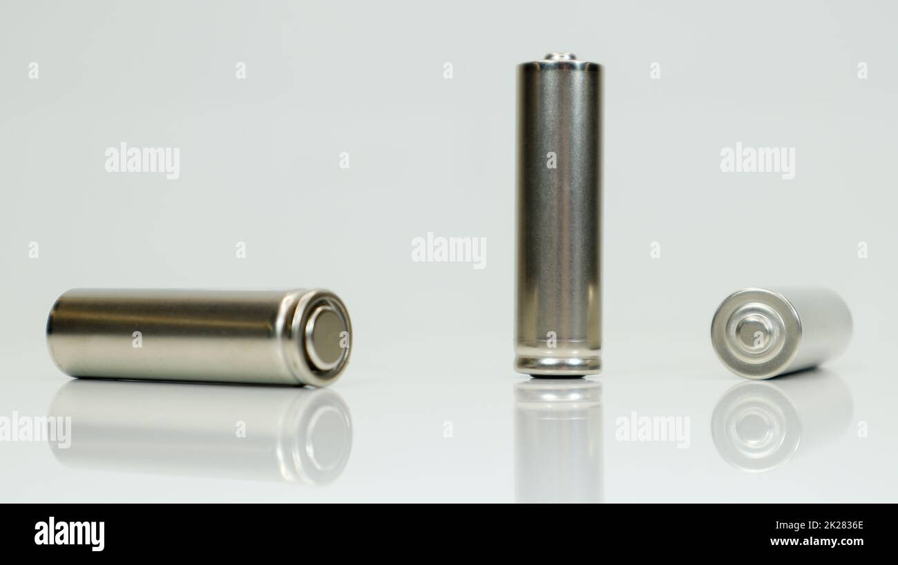 AA alkaline rechargeable batteries on white glossy background with