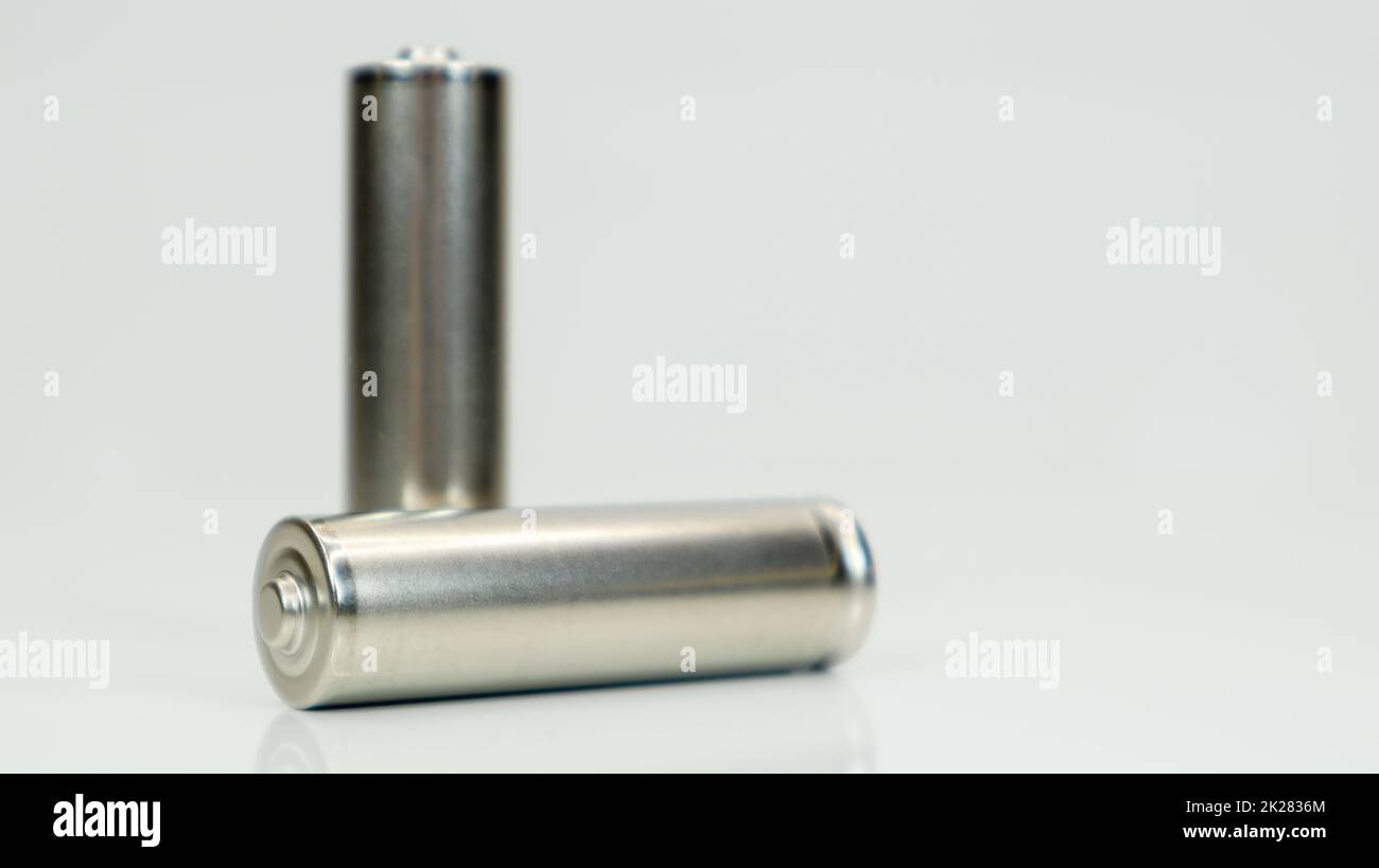 AA alkaline rechargeable batteries on white glossy background with