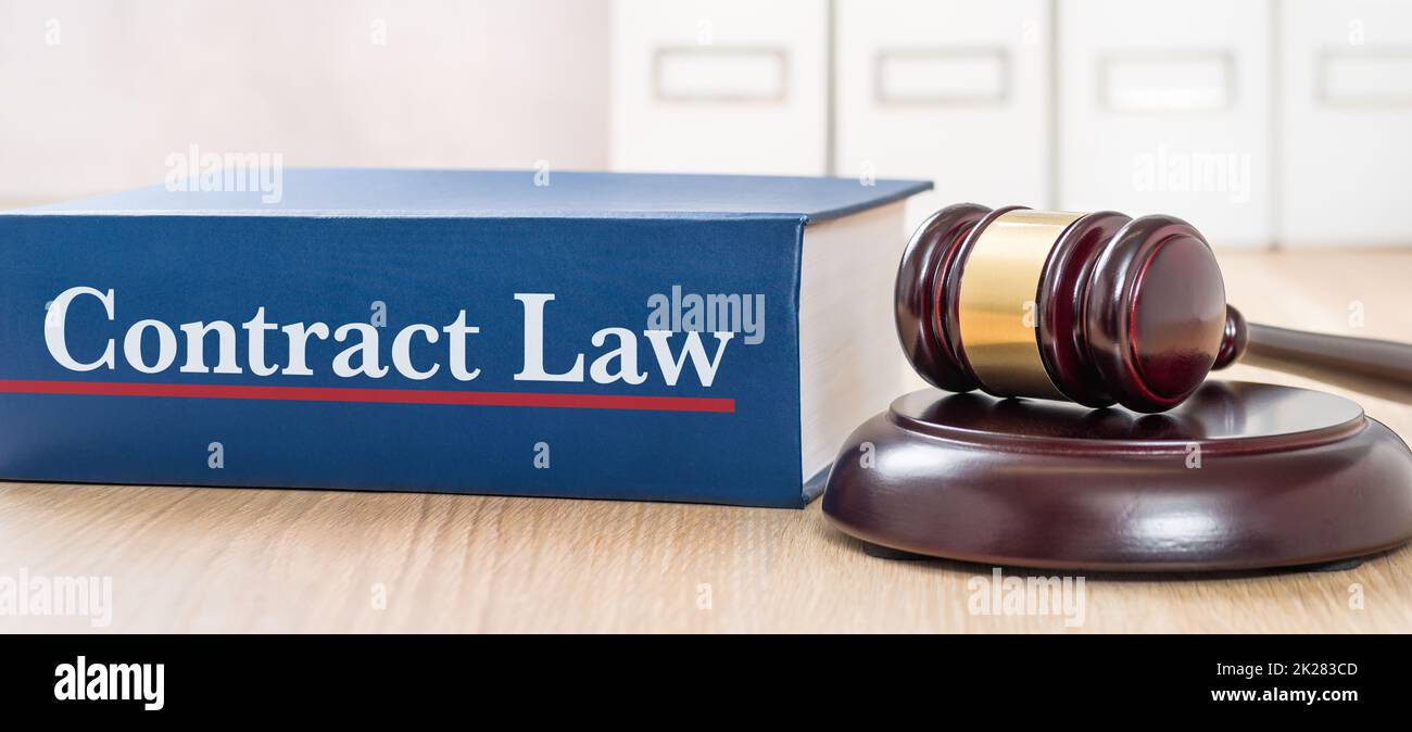 A law book with a gavel - Contract law Stock Photo