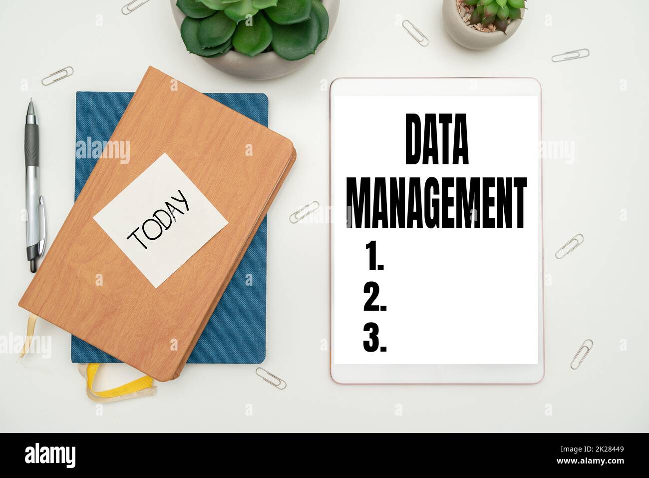 Hand writing sign Data Management. Business overview The practice of organizing and maintaining data processes Office Supplies Over Desk With Keyboard And Glasses And Coffee Cup For Working Stock Photo