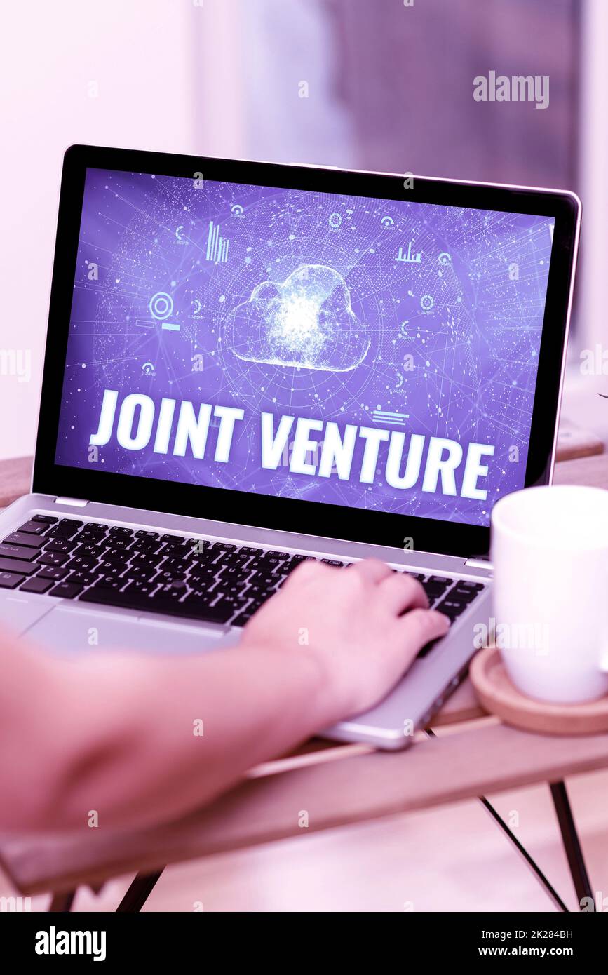 Sign displaying Joint Venture. Internet Concept business partnership invested jointly by two or more companies Stock Photo