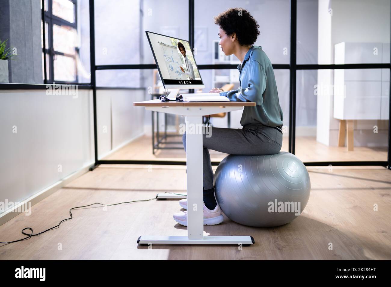 Female office using exercise ball hires stock photography and images