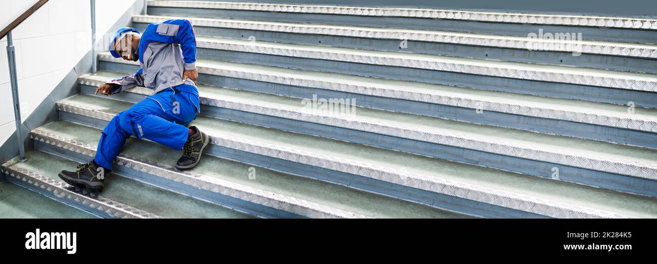 Worker Man Lying On Staircase Stock Photo