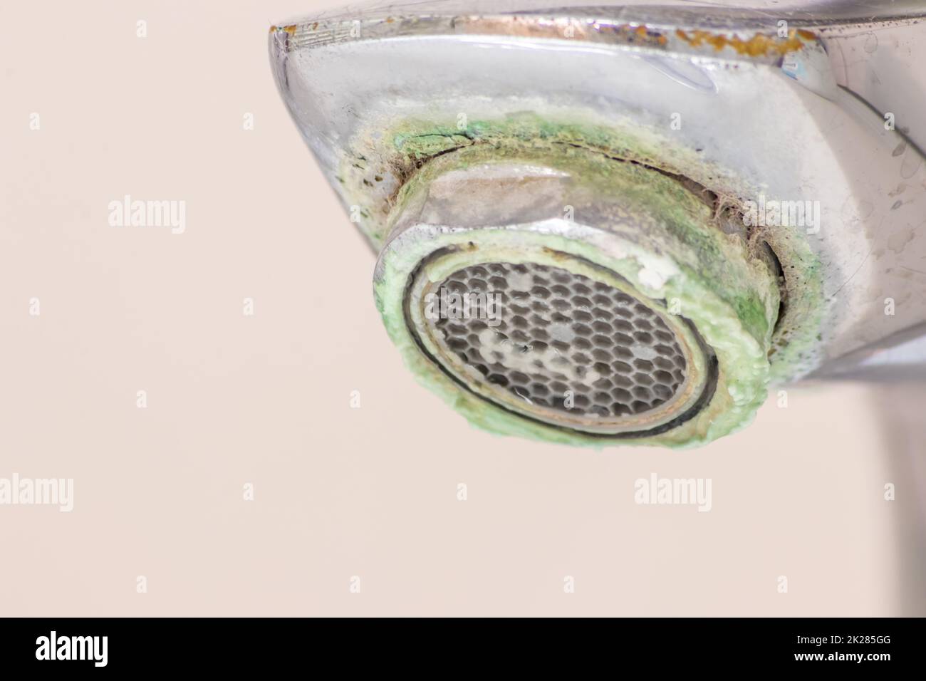 Old scaled faucet as calcified chrome handle in the bathroom needs