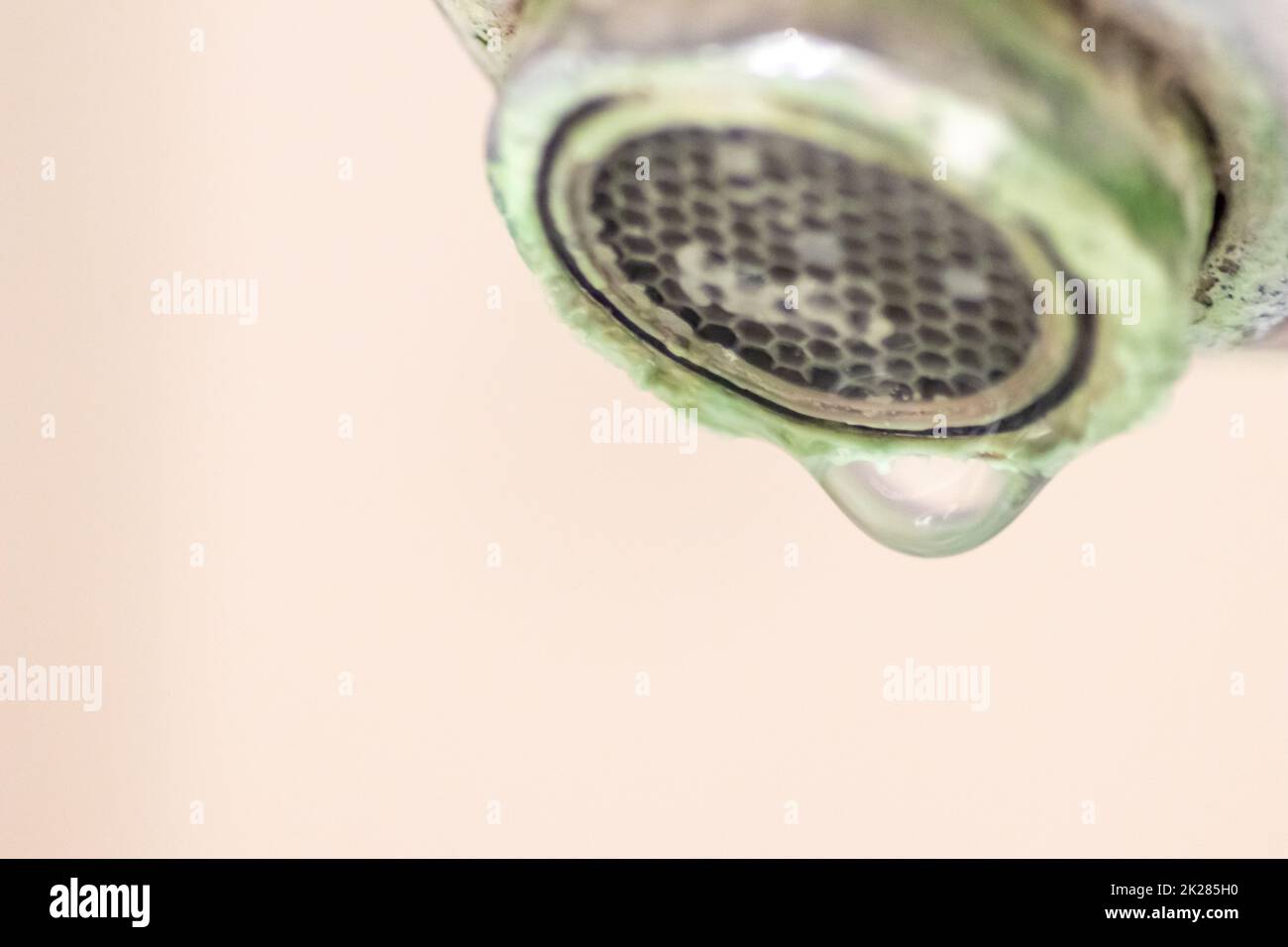 Old scaled faucet as calcified chrome handle in the bathroom needs