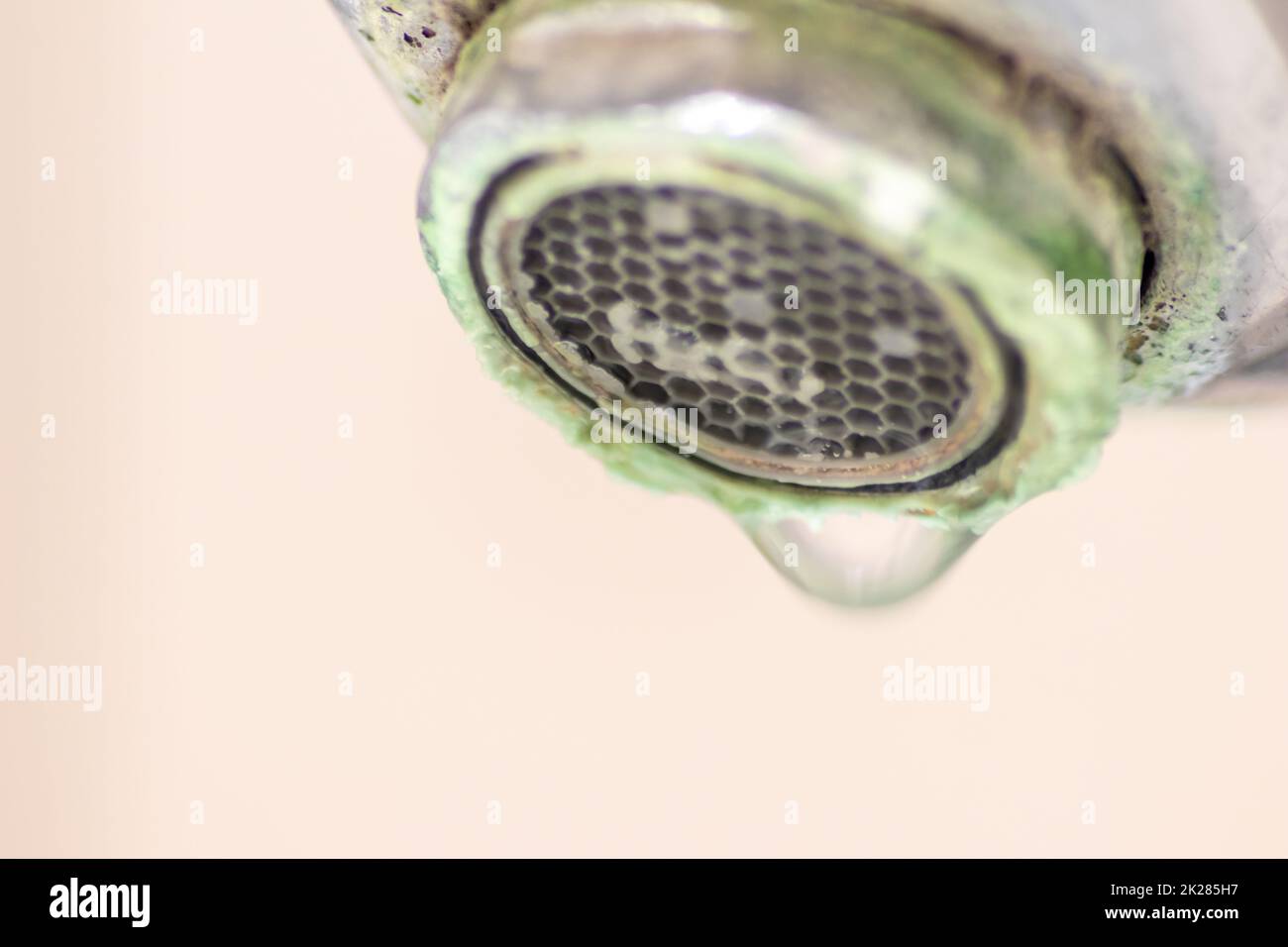 Old scaled faucet as calcified chrome handle in the bathroom needs