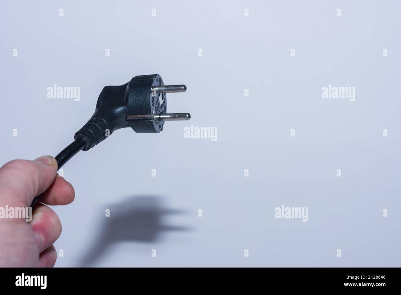plug from electricity held oblique in one hand save electricity left