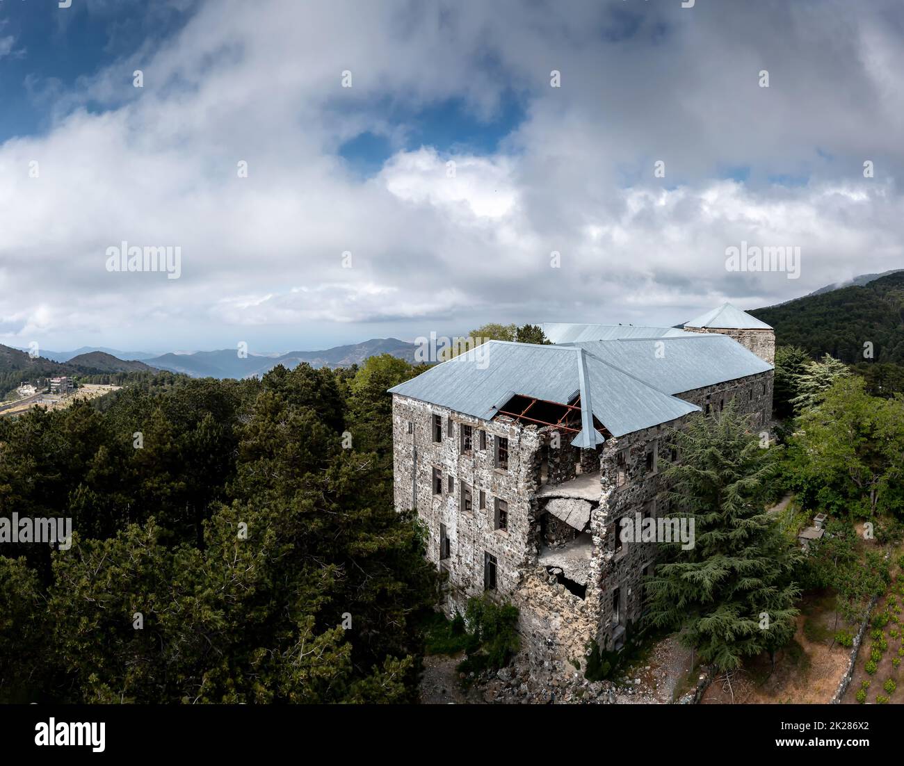 Birds eye view of old abandoned stone built building in mountain forest Stock Photo