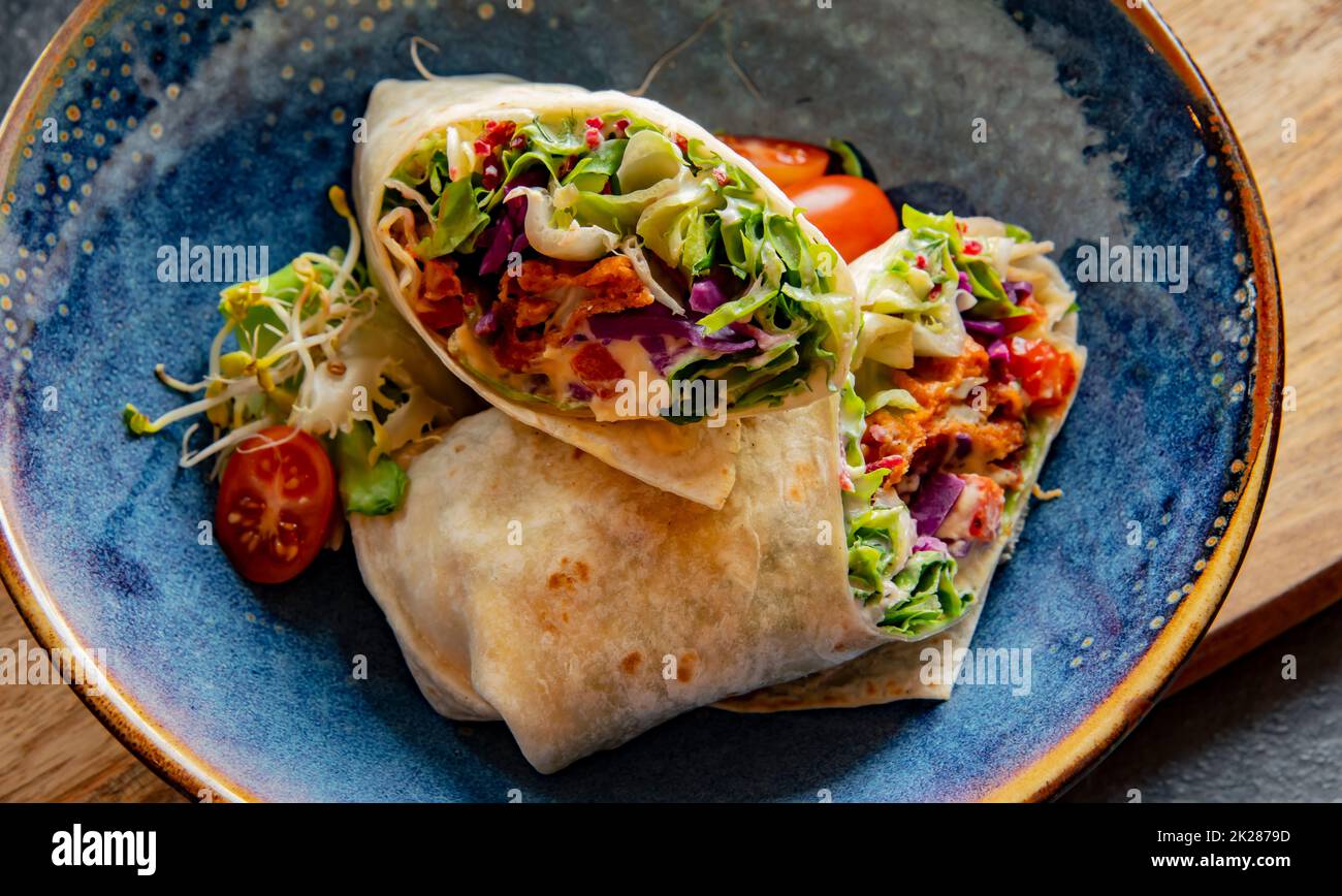 A bowl with two pieces of vegetarian tortilla Stock Photo
