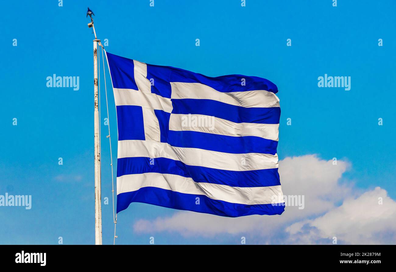 Greek blue and white flag with blue sky background Greece. Stock Photo