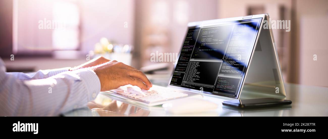 Programmer Or Coder At Office Desk Stock Photo